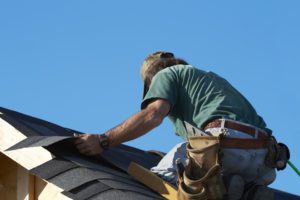 A man working on the roof of his home.