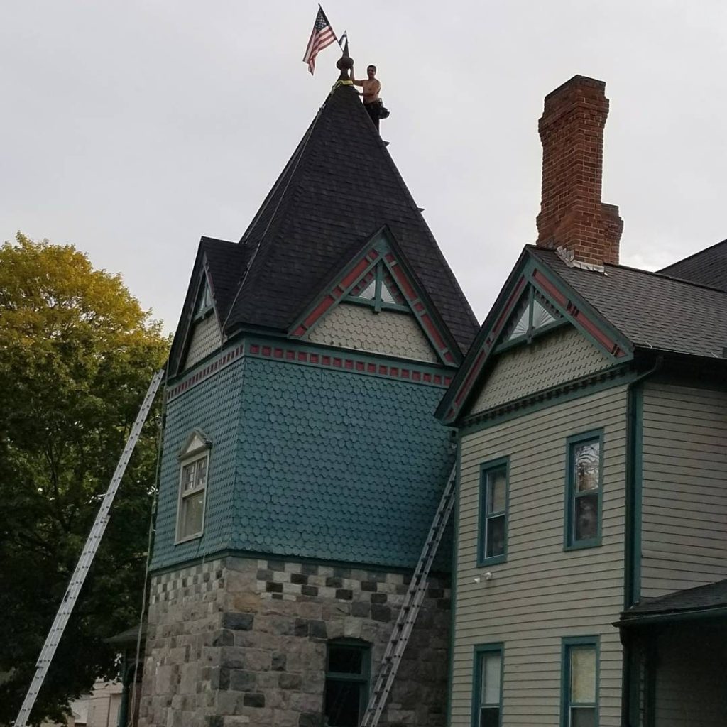 Expert roofer completing a new roof installation project on site.