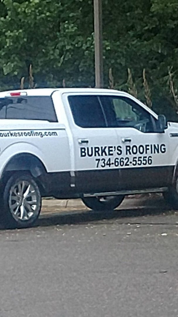 A white truck with the name burke 's roofing on it.